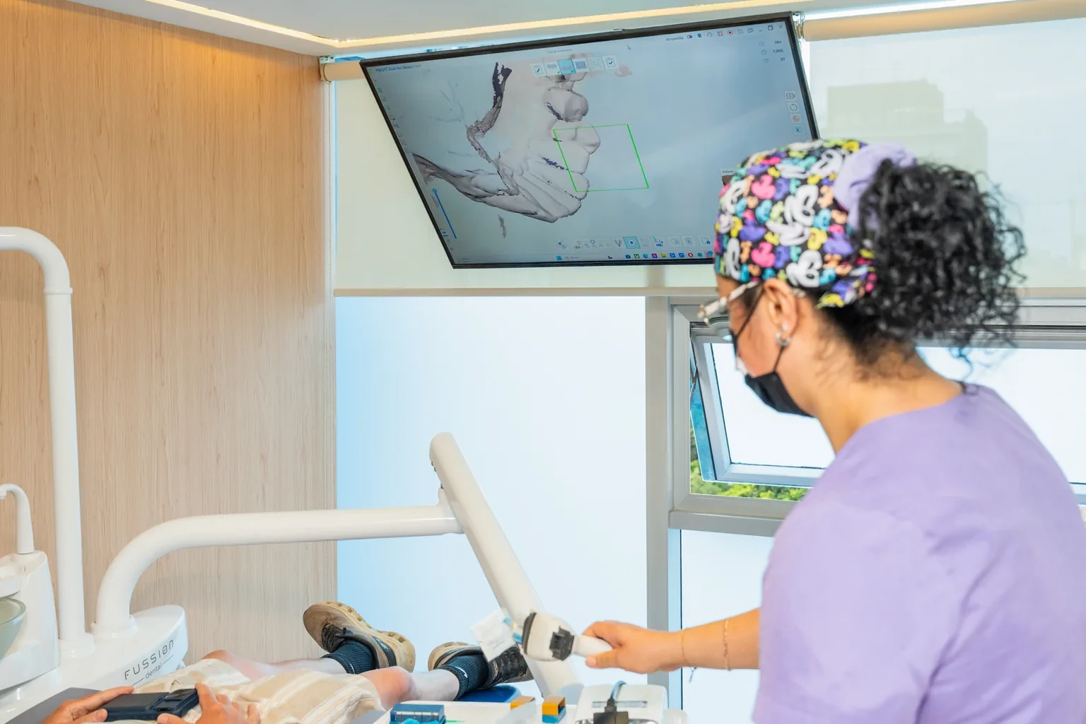 Dentist reviewing a dental scan screen during restorative planning for an old crown concern.